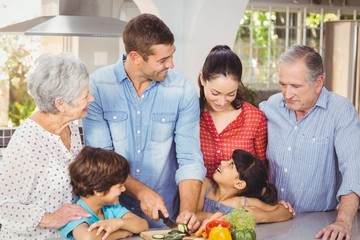 Happy family preparing food in kitchen