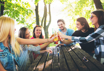 Group of young people cheering, having fun outdoors