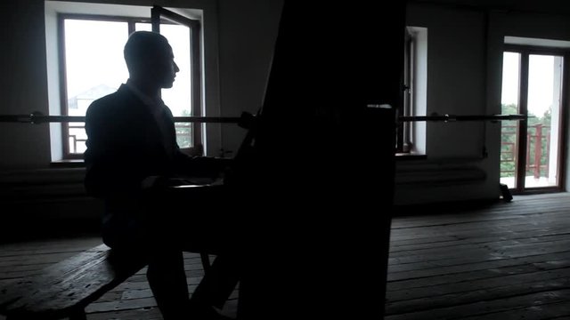 Girl is dancing in a hall while a guy playing piano
