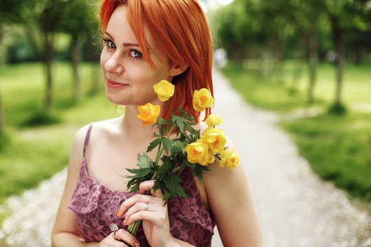 Red Heair Woman Holding Spring Flowers