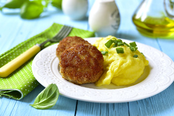Fish citlets garnished with potato puree.