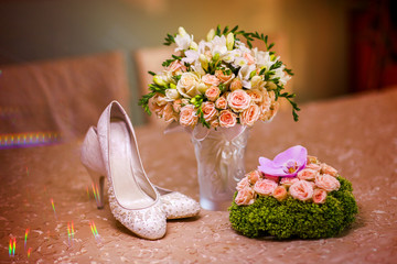 Beautiful wedding bouquet and bride's shoes. 