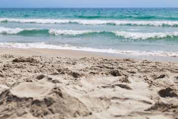 Sand beach and sea waves. Natural background.