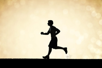 Fototapeta na wymiar silhouette man running on gold background