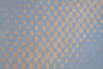 Cardboard background with gold dots and circles.