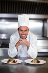 Portrait of smiling chef standing in kitchen