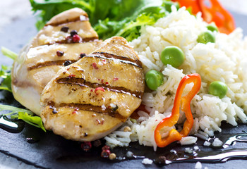 Delicious fried chicken breast and rice with chilli and salad