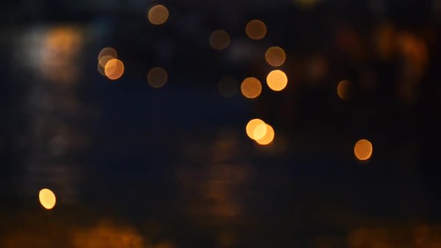 Out of focus candle offerings twinkling on river Ganges.