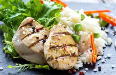 Delicious fried chicken breast and rice with chilli and salad
