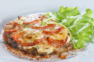 beef, baked with cheese with tomato serving salad