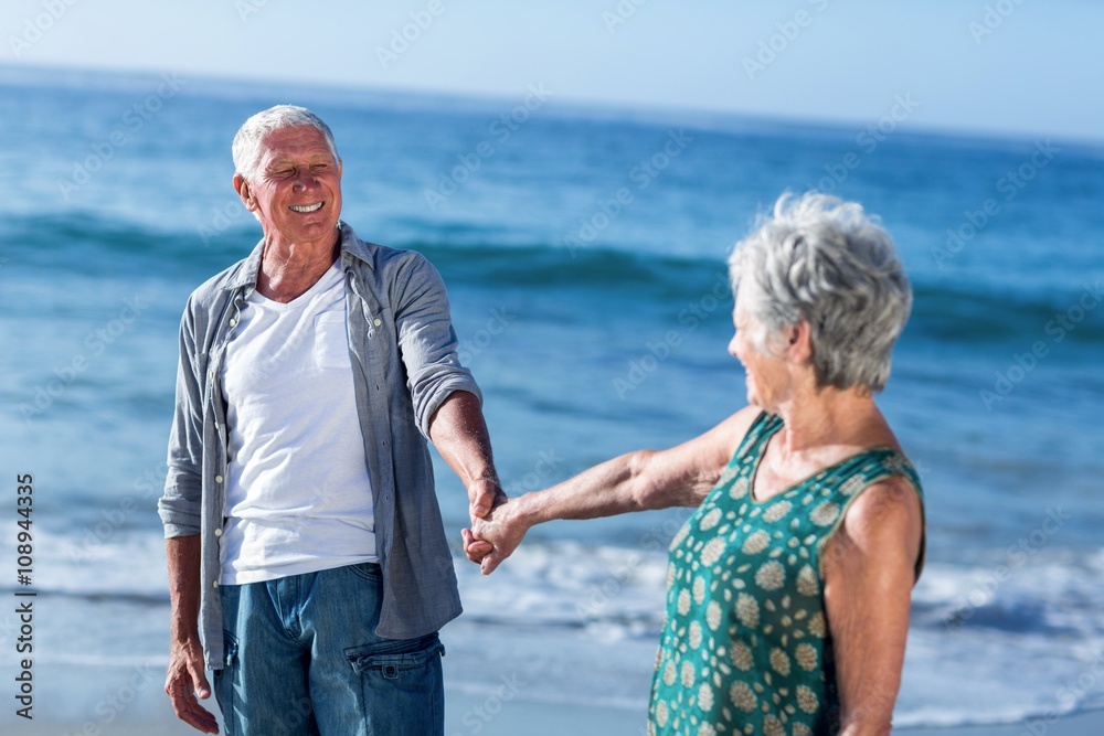 Wall mural Senior couple holding hands