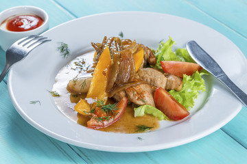 veal slices are served with sweet pepper, onion and fresh tomato