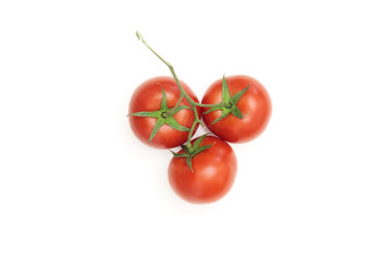 Three ripe tomatoes on a white background
