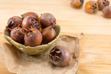 Medlars on an old wooden table