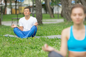 Fototapeta premium Having yoga practice in park