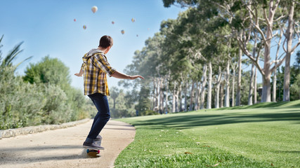 Handsome young man with a skateboard ready to ride © Sergey Nivens