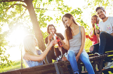 Group of young people cheering, having fun outdoors