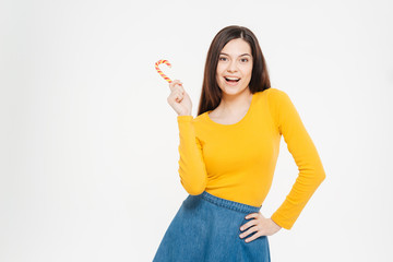 Cheerful woman holding lollipop