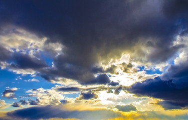 Colorful sunrise, sunset clouds and sun rays