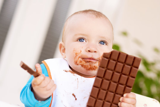 Baby boy eating chocolate