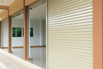 Obraz premium roller shutter door in warehouse building