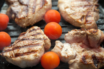Grilled bbq steaks with fresh herbs and tomatoes