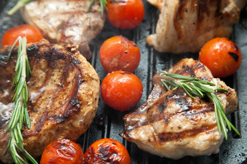 Grilled bbq steaks with fresh herbs and tomatoes