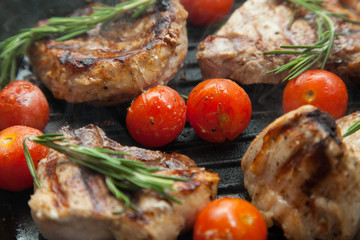 Grilled bbq steaks with fresh herbs and tomatoes
