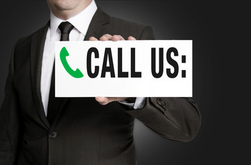 call us sign is held by businessman background