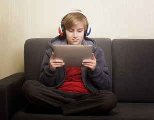 Boy with a digital tablet sitting on the couch