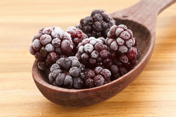 Macro view on frozen Blackberry fruits in spoon