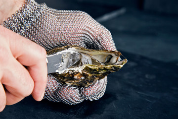 Opening oyster with knife - 108954965