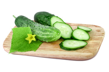 Organic cucumbers on a cutting board isolated on white