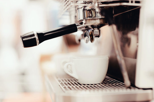 Close-up of espresso preparing in coffee machine. Service and catering concept