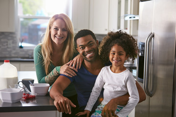 Portrait of mixed race couple and daughter in the kitchen