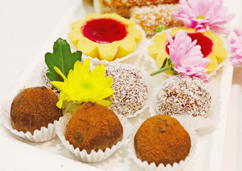 set of cakes and cookies decorated with natural flowers