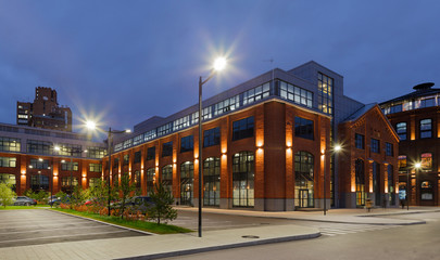 Extensive office complex exterior in loft style. Red brick buildings of former factory, gasholders....