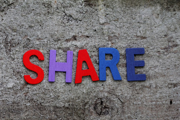 word "Share"on old rusty 
wooden background
