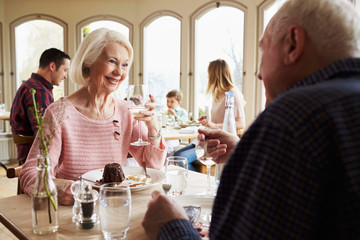 Senior Couple Enjoying Dessert In Restaurant Together