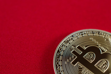 Golden Bitcoins (digital virtual money) on red background