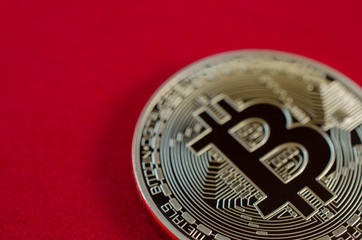Golden Bitcoins (digital virtual money) on red background