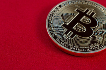 Golden Bitcoins (digital virtual money) on red background