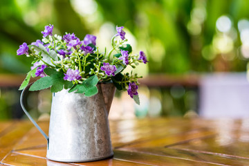 Beautiful flowers in vase on wooden table ,soft focus