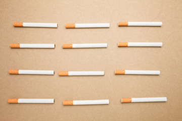 A Cigarettes are flat lay on brown background