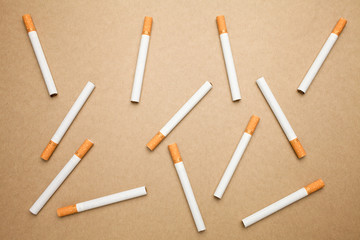 A Cigarettes are flat lay on brown background