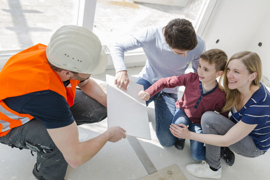 Construction worker showing family tile sample