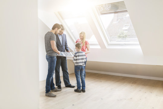Estate agent showing family sample card in their new penthouse