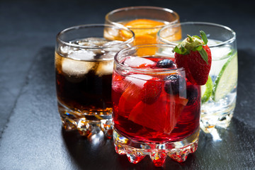 Fototapeta na wymiar iced fruit drinks on a dark background