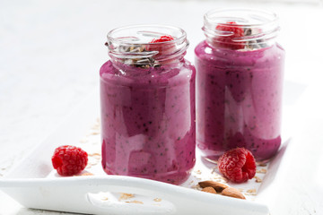 raspberry smoothie with oatmeal and chocolate on white table