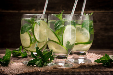 detox water with a lemon, lime and mint on a wooden table